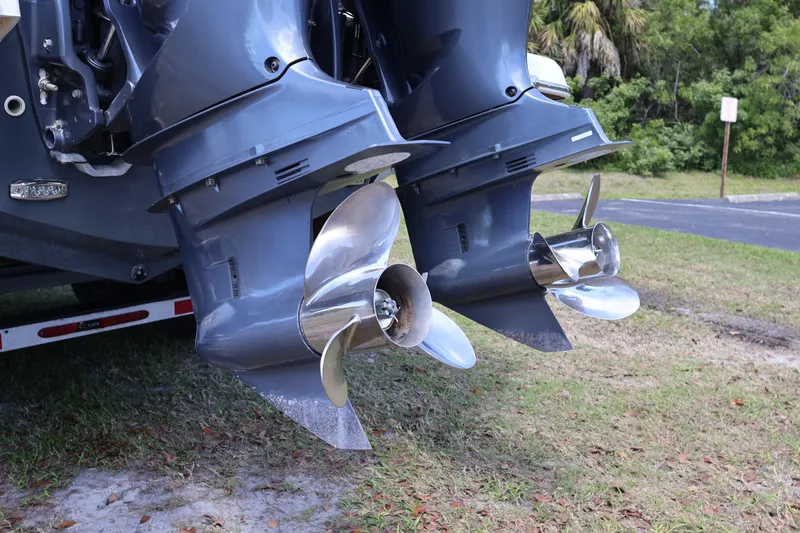 Slide: The Image of Twin outboard motors on a 2019 Regal 29 OBX boat, featuring shiny propellers. - 9