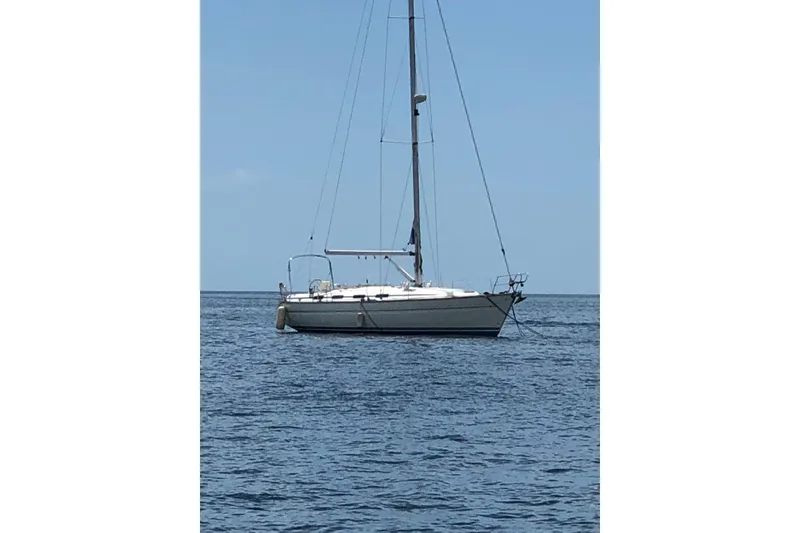The Image of Sailboat Bavaria 43, 2001 model, anchored on calm sea under clear blue sky. - 1
