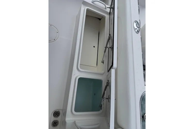 Slide: The Image of Open storage compartments on a 2019 Edgewater 230CC boat. - 18
