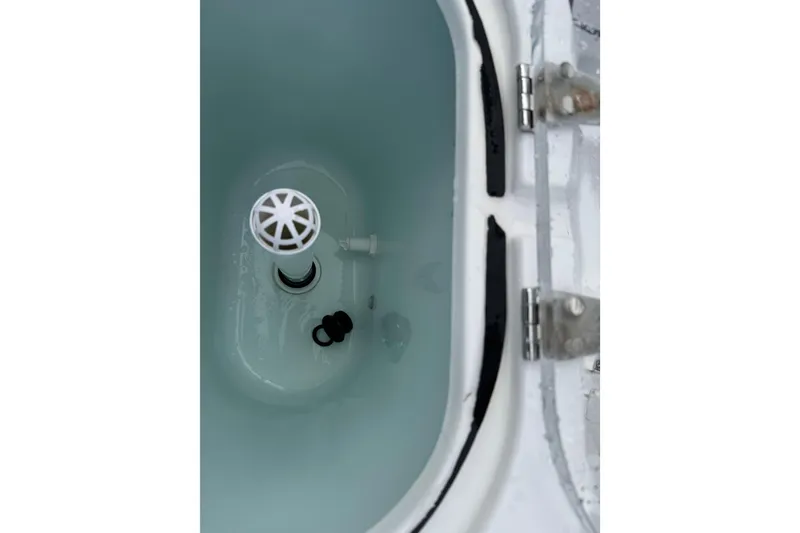 Slide: The Image of Livewell interior of 2019 Edgewater 230CC boat, showing water and drain components. - 20