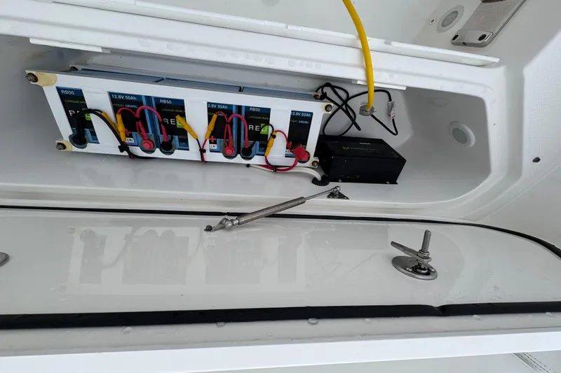 Slide: The Image of Battery compartment of 2019 Edgewater 230CC boat with lithium batteries and wiring. - 34