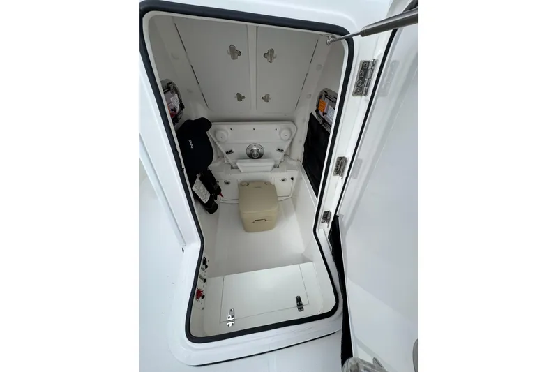 Slide: The Image of Interior view of 2019 Edgewater 230CC boat cabin with storage and seating. - 37