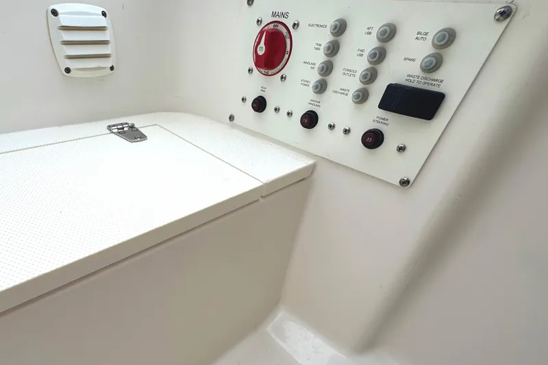 Slide: The Image of Control panel of a 2019 Edgewater 230CC boat, featuring various switches and buttons. - 38