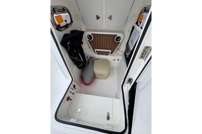 Slide: The Image of 2019 Edgewater 230CC boat interior with storage, seating, and equipment. - 40