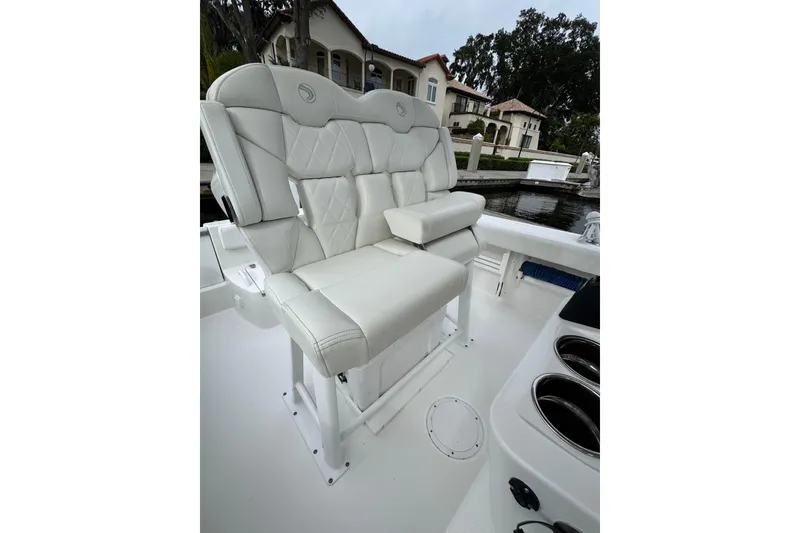 Slide: The Image of Luxurious seating on 2019 Edgewater 230CC boat, featuring white leather upholstery. - 51