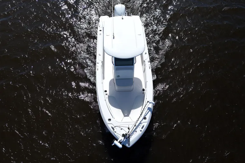 Slide: The Image of Aerial view of 2019 Edgewater 230CC boat cruising on dark water. - 8