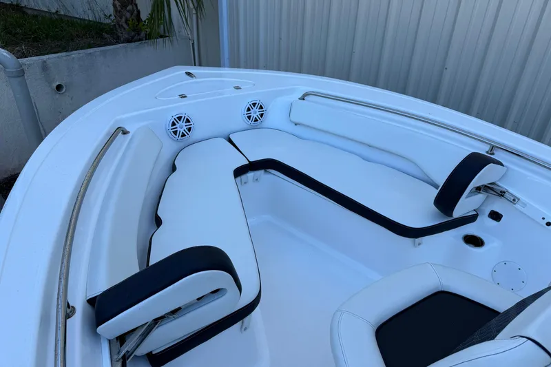 Slide: The Image of 2022 Tidewater 198 CC Adventure boat interior with cushioned seating and speakers. - 11