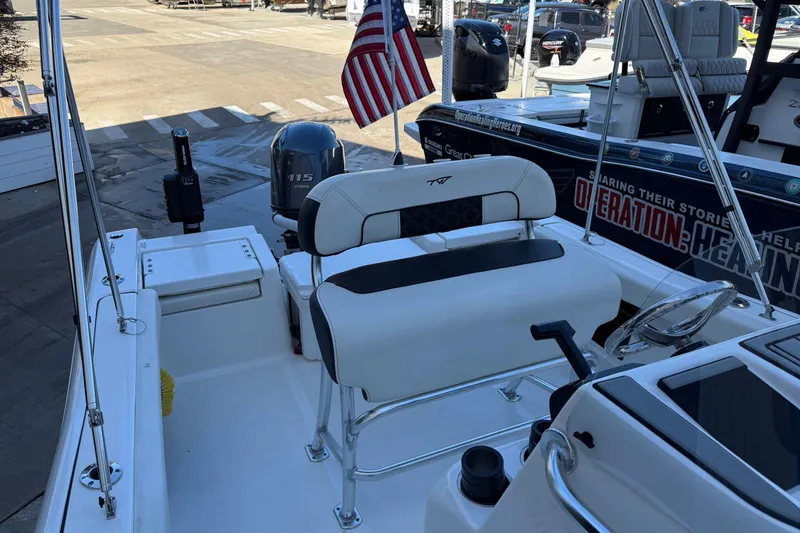 Slide: The Image of 2022 Tidewater 198 CC Adventure boat interior with seating and steering wheel. - 12