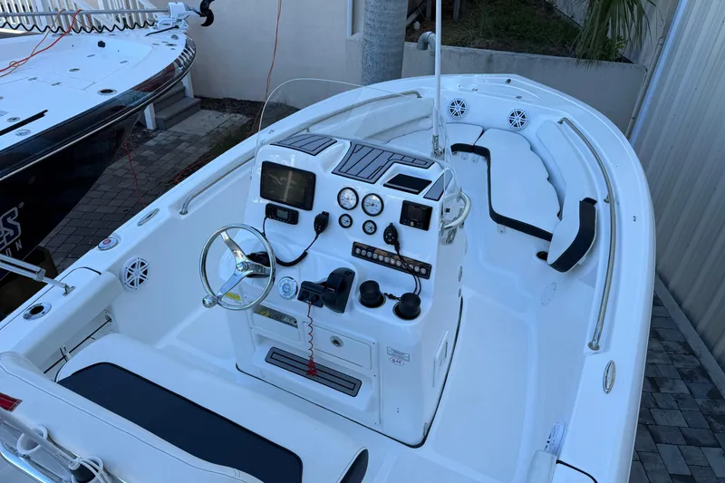 Slide: The Image of 2022 Tidewater 198 CC Adventure boat interior with steering console and seating. - 14