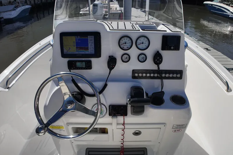 Slide: The Image of Control panel of 2022 Tidewater 198 CC Adventure boat with steering wheel and gauges. - 19