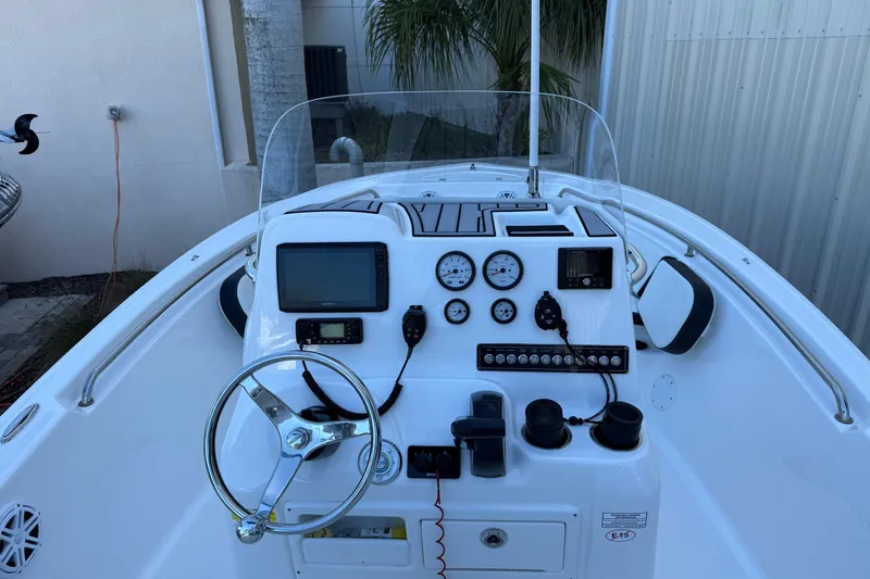 Slide: The Image of 2022 Tidewater 198 CC Adventure boat dashboard with steering wheel and navigation instruments. - 20