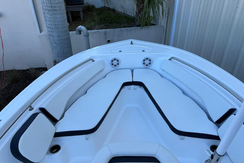 Slide: The Image of 2022 Tidewater 198 CC Adventure boat interior with cushioned seating and speakers. - 21