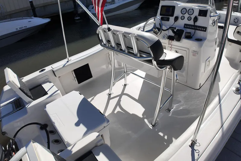 Slide: The Image of 2022 Tidewater 198 CC Adventure boat interior with helm, seating, and fishing rod holders. - 29