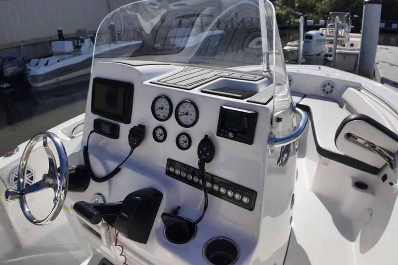 Slide: The Image of 2022 Tidewater 198 CC Adventure boat dashboard with steering wheel and control panel. - 33