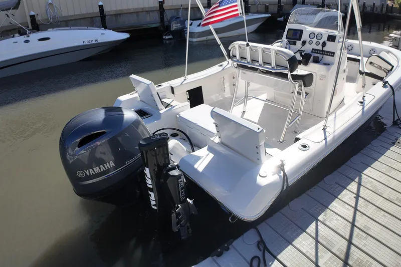 Slide: The Image of 2022 Tidewater 198 CC Adventure boat docked, featuring Yamaha outboard motor and American flag. - 35