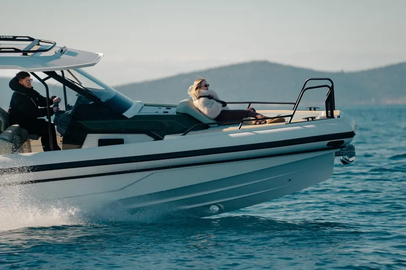 Slide: The Image of 2026 Highfield ADV7 boat cruising with passengers on a sunny day. - 1