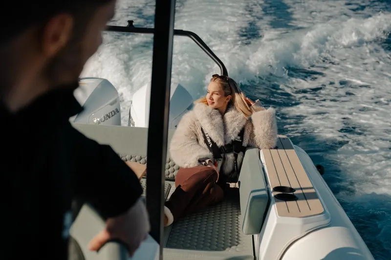 Slide: The Image of Woman relaxing on a 2026 Highfield ADV7 boat, enjoying a sunny day at sea. - 5