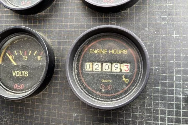 Slide: The Image of 1986 Galaxie Bowrider dashboard showing engine hours and voltmeter readings. - 10