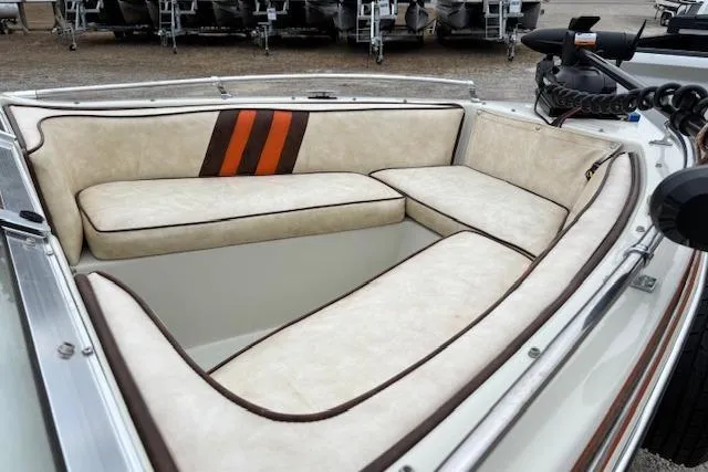 Slide: The Image of 1986 Galaxie Bowrider boat interior with beige and orange cushioned seating. - 11