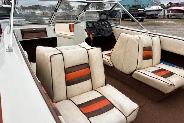 Slide: The Image of 1986 Galaxie Bowrider boat interior with retro upholstery and steering console. - 13