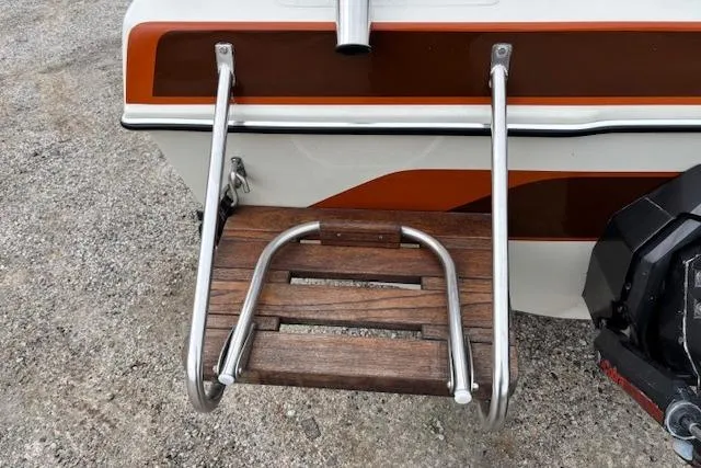 Slide: The Image of 1986 Galaxie Bowrider boat with stainless steel swim ladder and wooden platform. - 16
