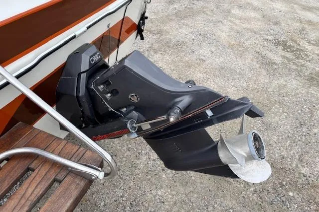 Slide: The Image of 1986 Galaxie Bowrider boat with OMC outboard motor on gravel surface. - 23