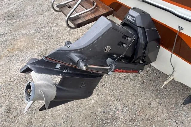 Slide: The Image of 1986 Galaxie Bowrider boat with OMC outboard motor on gravel surface. - 25