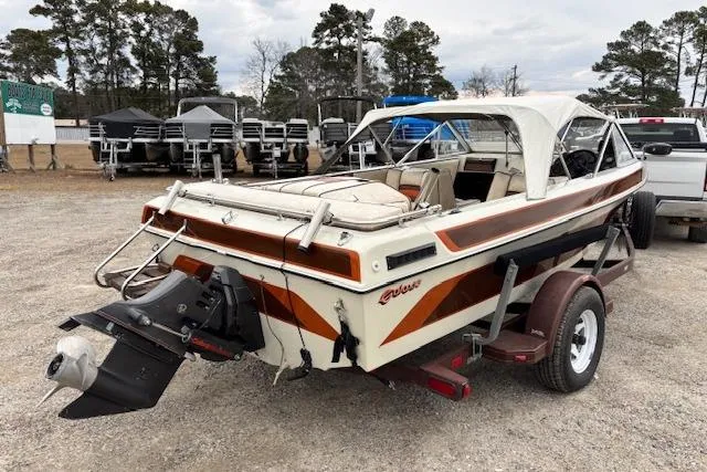 Slide: The Image of 1986 Galaxie Bowrider boat on trailer, parked outdoors with trees in background. - 5