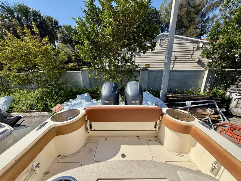 Slide: The Image of 2015 Scout 275 LXF boat with twin outboard engines in a garden. - 11