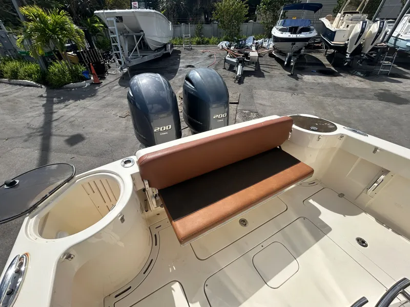 Slide: The Image of 2015 Scout 275 LXF boat with dual outboard engines at dock. - 12