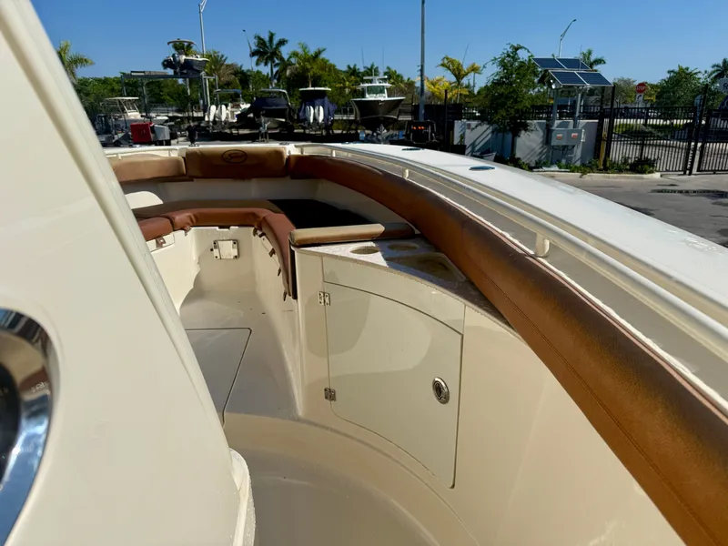 Slide: The Image of 2015 Scout 275 LXF boat with brown upholstery at the dock. - 14