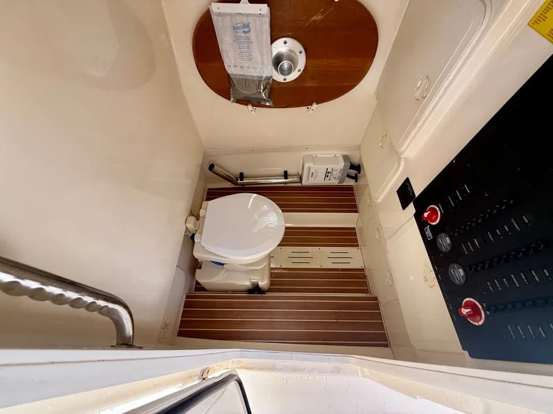 Slide: The Image of Interior of 2015 Scout 275 LXF featuring toilet and wood paneling. - 16