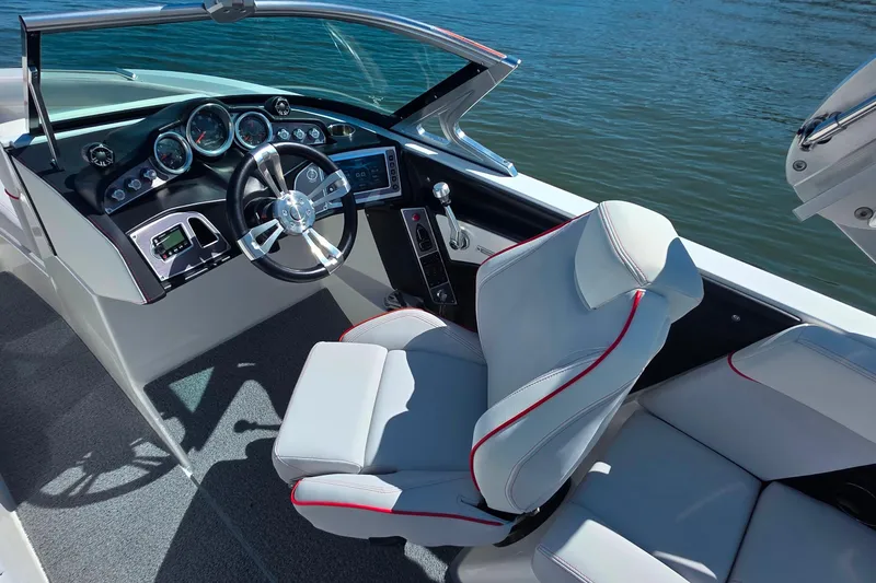 Slide: The Image of 2018 MasterCraft XT23 boat interior with sleek dashboard and comfortable seating. - 12