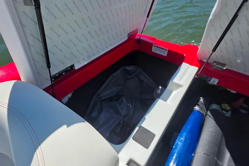 Slide: The Image of Open storage compartment in 2018 MasterCraft XT23 boat, showing interior details. - 22