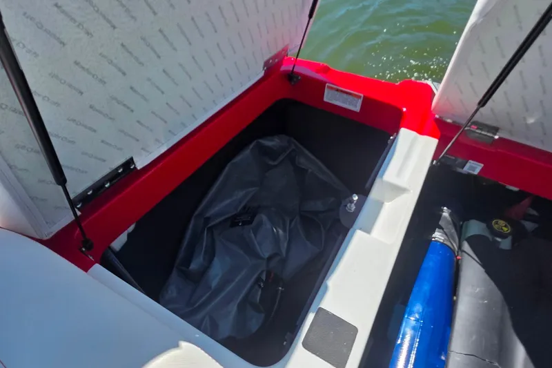 Slide: The Image of Open storage compartment in 2018 MasterCraft XT23 boat, showing interior details. - 23