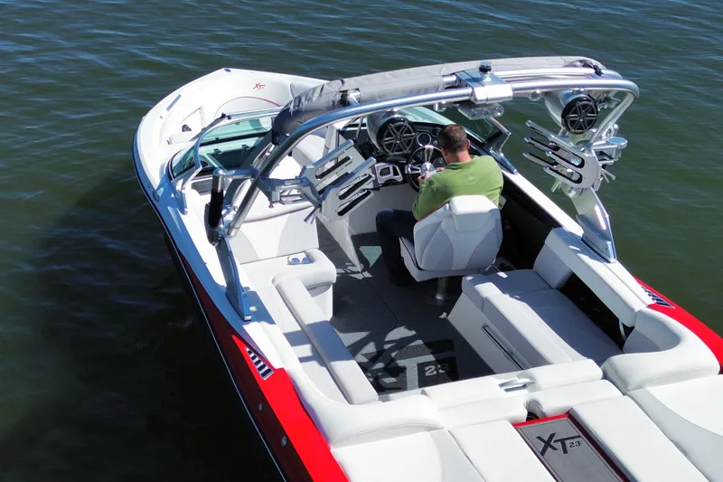 Slide: The Image of 2018 MasterCraft XT23 boat on water, featuring sleek design and modern amenities. - 3