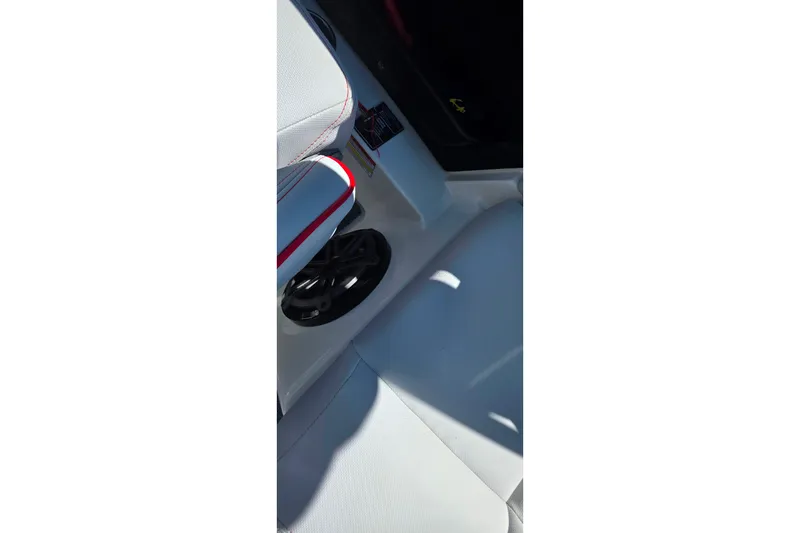 Slide: The Image of 2018 MasterCraft XT23 interior with white and red seating, featuring a built-in speaker. - 31