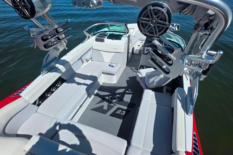 Slide: The Image of 2018 MasterCraft XT23 boat interior with white seating and advanced audio system. - 32