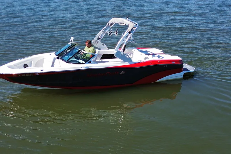 Slide: The Image of 2018 MasterCraft XT23 boat on water, featuring sleek design and vibrant colors. - 6