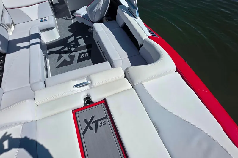 Slide: The Image of 2018 MasterCraft XT23 boat interior with white seating and XT23 logo. - 8
