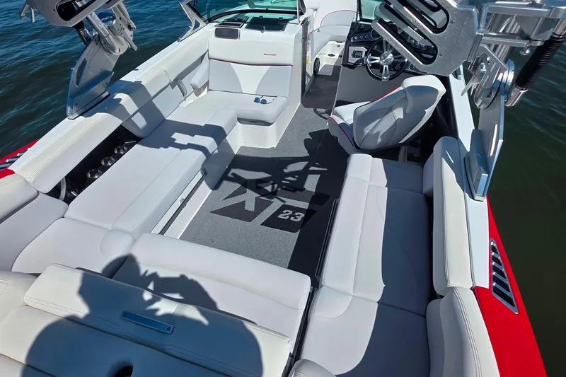 Slide: The Image of 2018 MasterCraft XT23 boat interior with white seating and modern dashboard. - 9