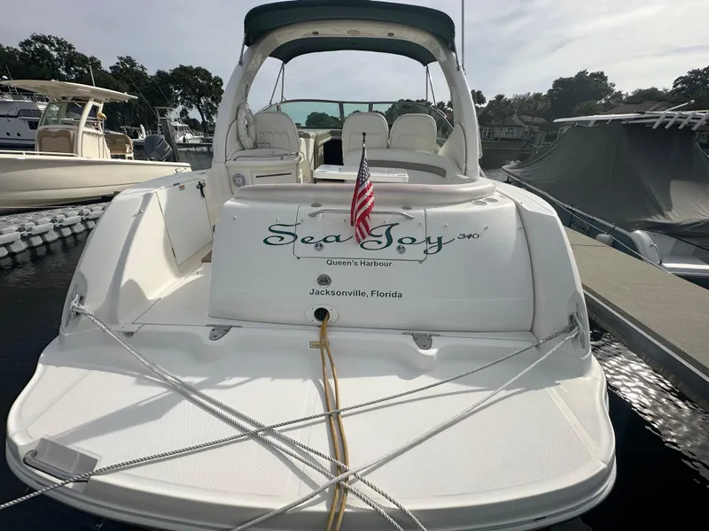 Slide: The Image of 2003 Sea Ray 340 Sundancer docked, rear view with American flag, Jacksonville, Florida. - 2