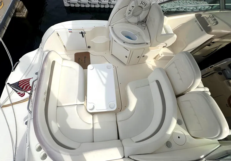 Slide: The Image of 2003 Sea Ray 340 Sundancer boat interior with white seating and table. - 28