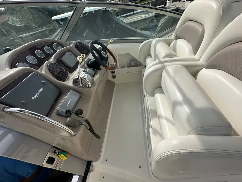 Slide: The Image of Cockpit of a 2003 Sea Ray 340 Sundancer with steering wheel and control panel. - 31