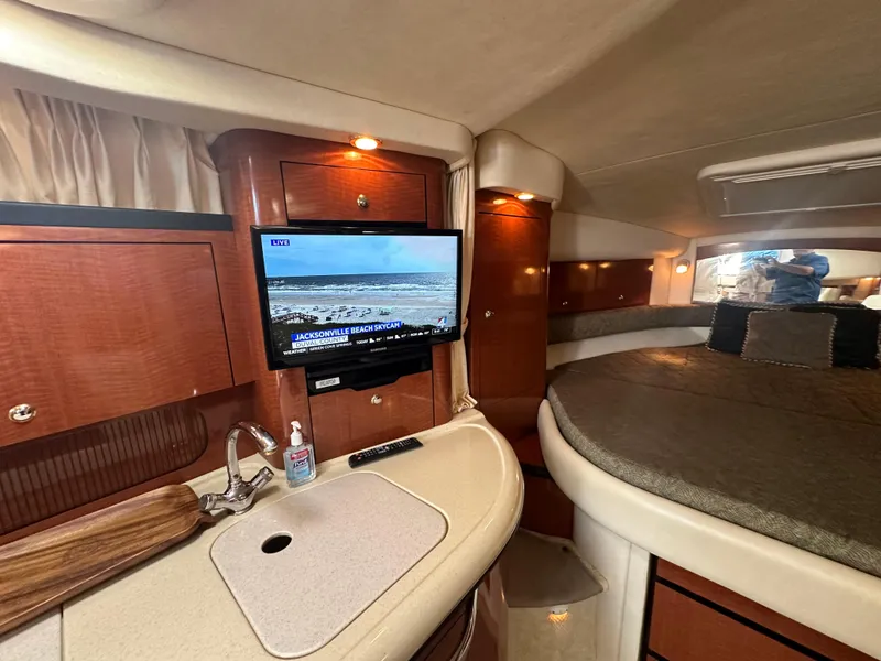 Slide: The Image of 2003 Sea Ray 340 Sundancer interior with kitchenette, TV, and sleeping area. - 41