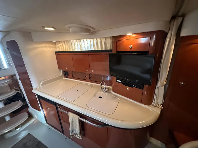 Slide: The Image of Interior of 2003 Sea Ray 340 Sundancer yacht with kitchenette and TV. - 43