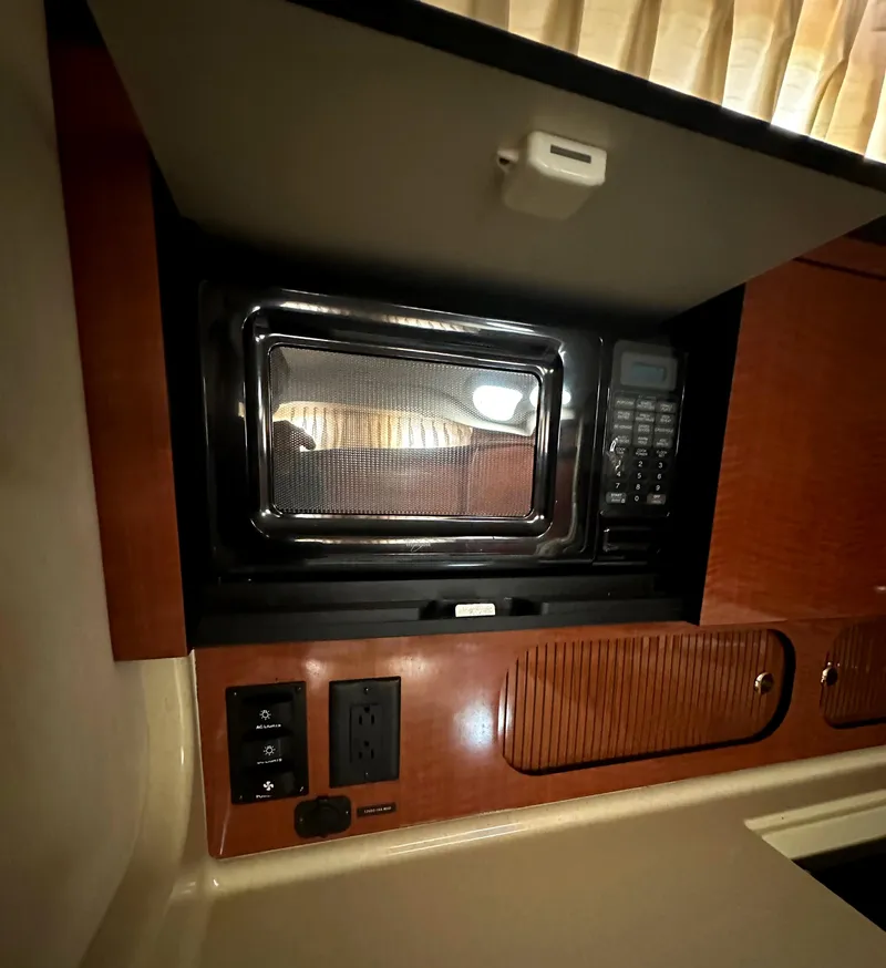 Slide: The Image of Microwave and cabinetry in 2003 Sea Ray 340 Sundancer yacht kitchen. - 46
