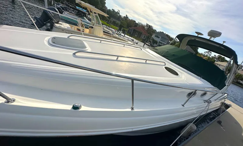 Slide: The Image of 2003 Sea Ray 340 Sundancer docked at a marina on a sunny day. - 8