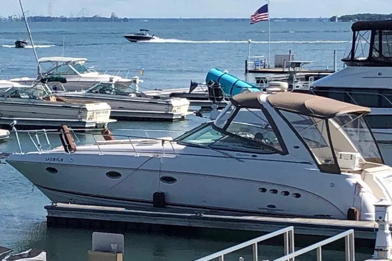 The Image of 2005 Chaparral Signature 350 yacht docked at marina with scenic water view. - 0