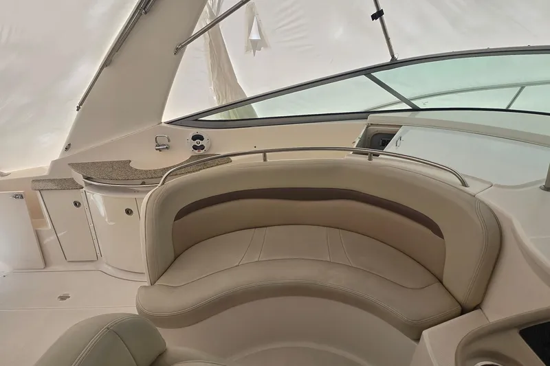 Slide: The Image of 2005 Chaparral Signature 350 boat interior with beige seating and kitchenette area. - 15